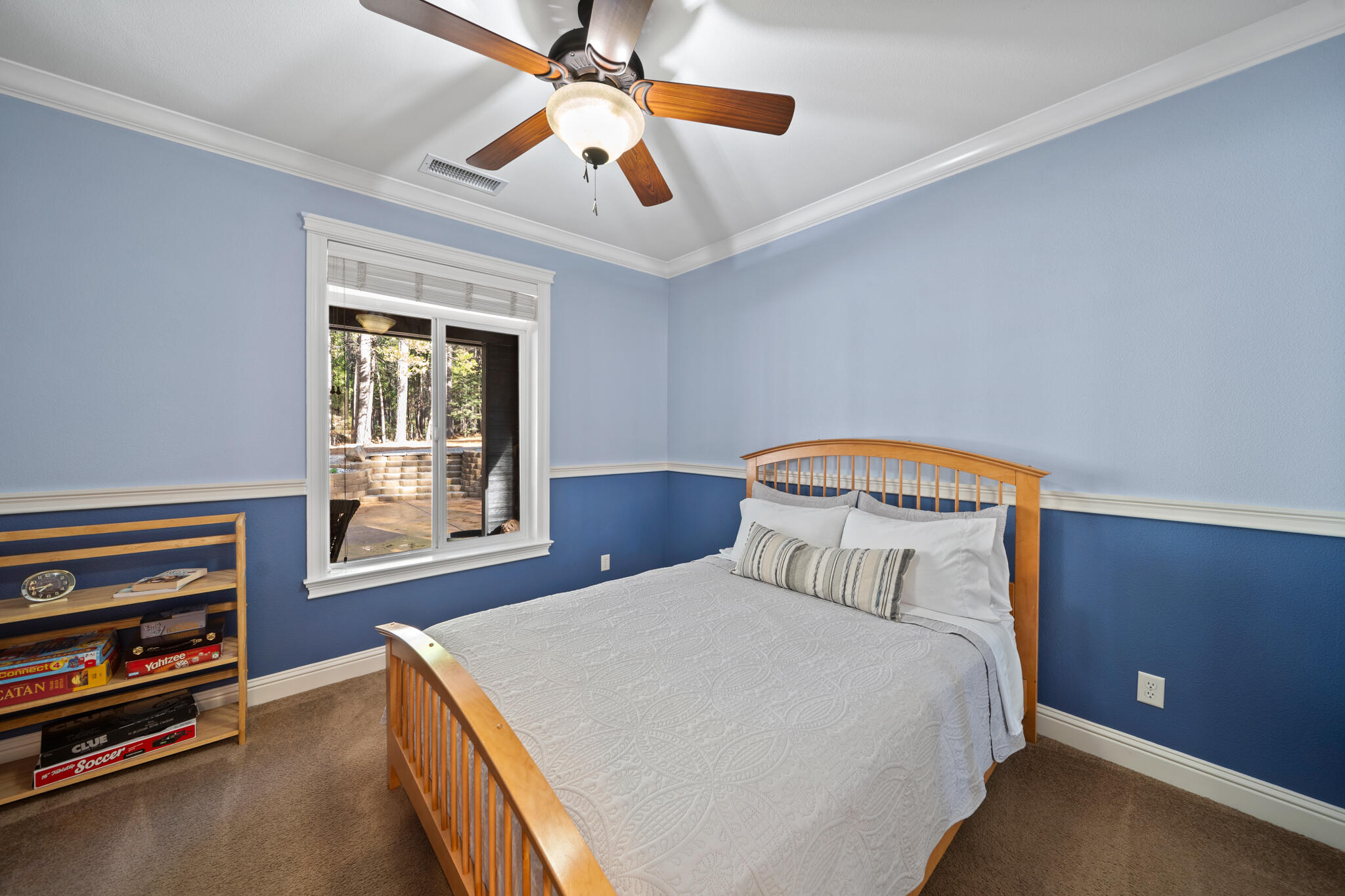 7795 Eastmoore Road Shingletown, CA 96088 - Photo 26 of 61 a bedroom with a bed and a chandelier