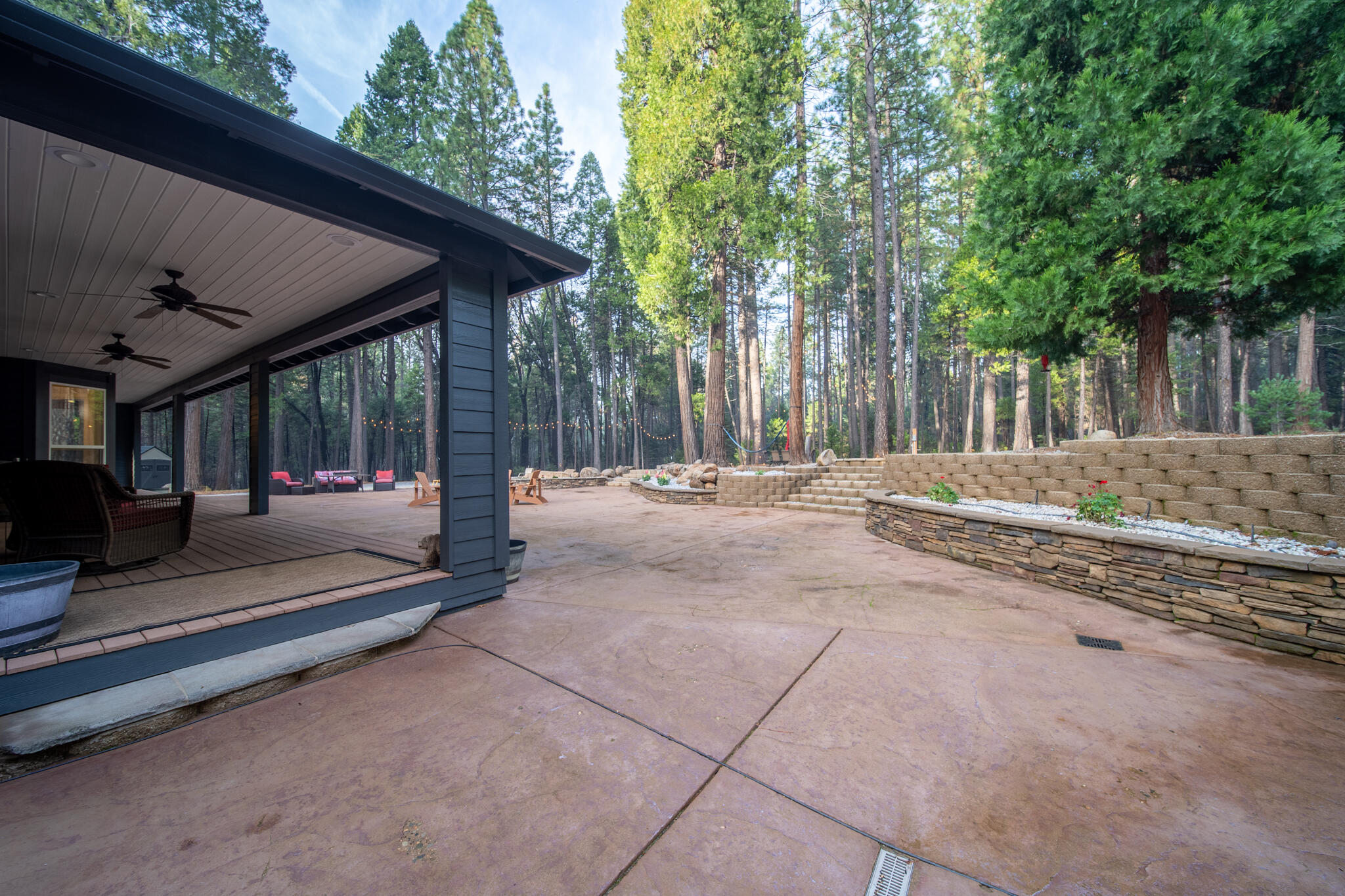 7795 Eastmoore Road Shingletown, CA 96088 - Photo 39 of 61 a view of a backyard with large trees and wooden fence