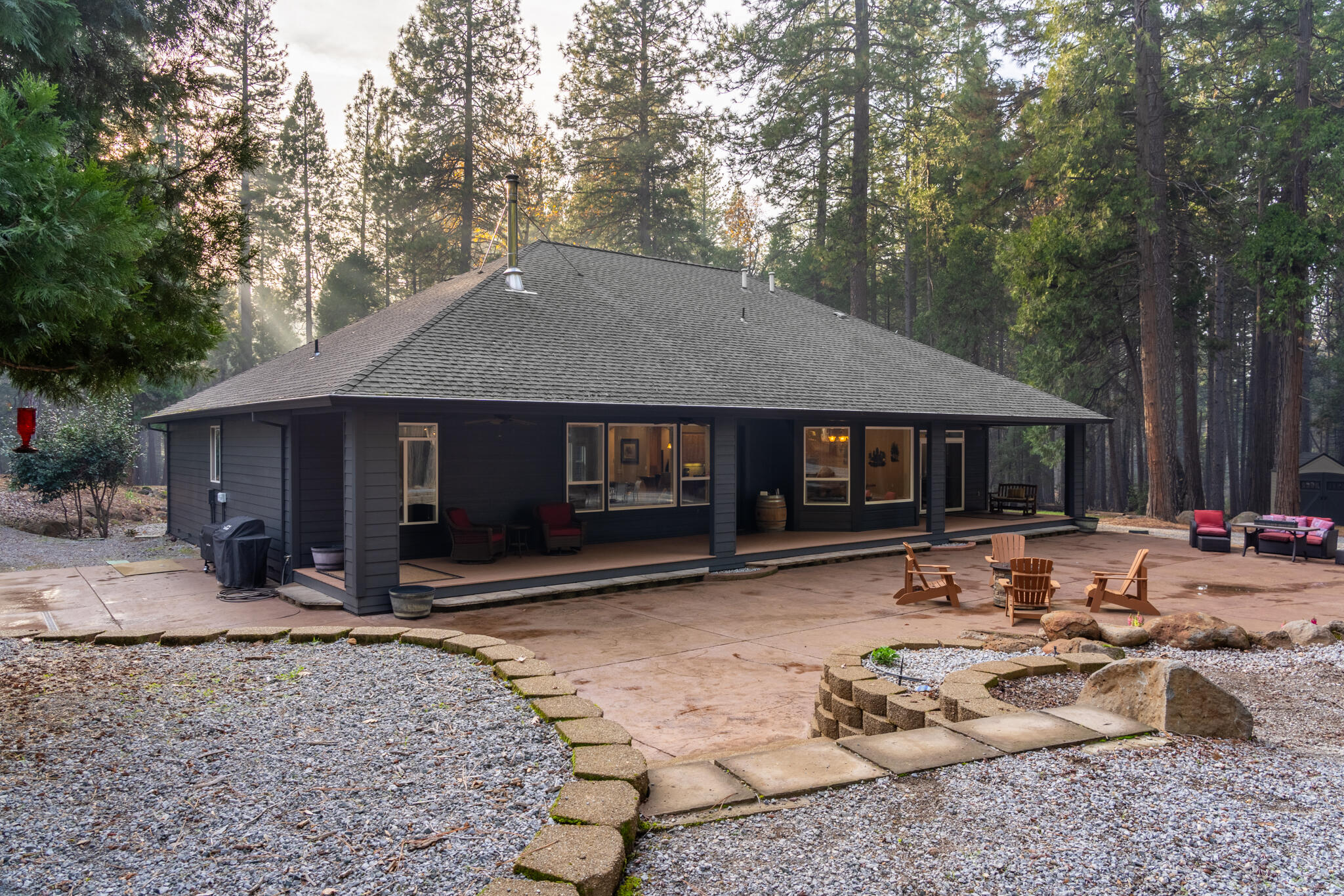 7795 Eastmoore Road Shingletown, CA 96088 - Photo 43 of 61 a front view of a house with a yard and trees
