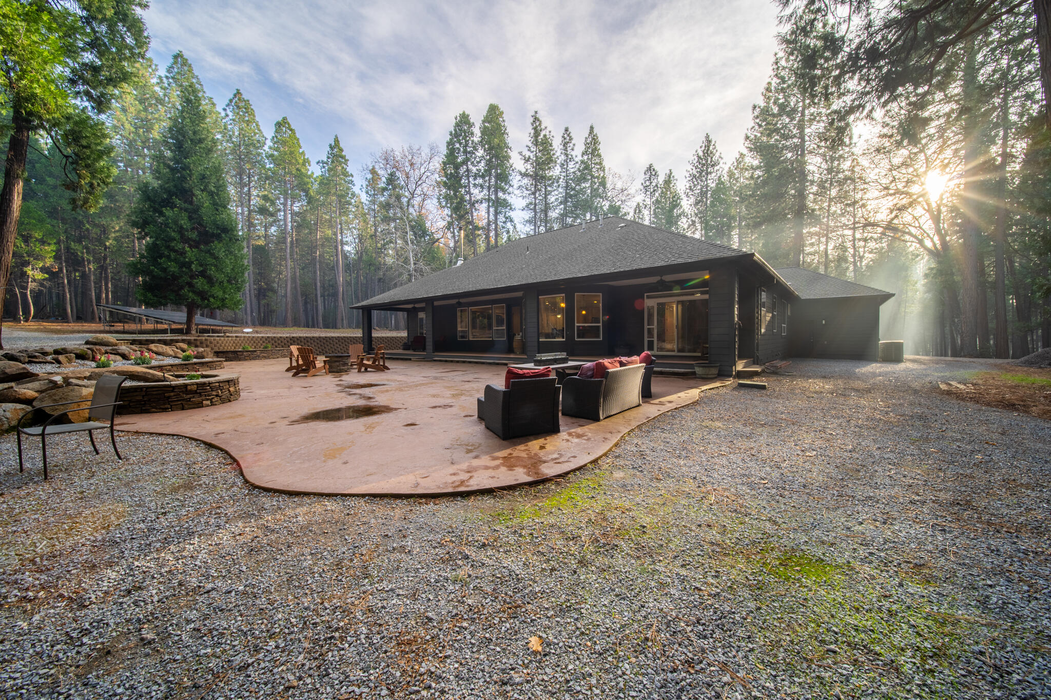 7795 Eastmoore Road Shingletown, CA 96088 - Photo 45 of 61 a view of a wooden house with a yard and sitting area