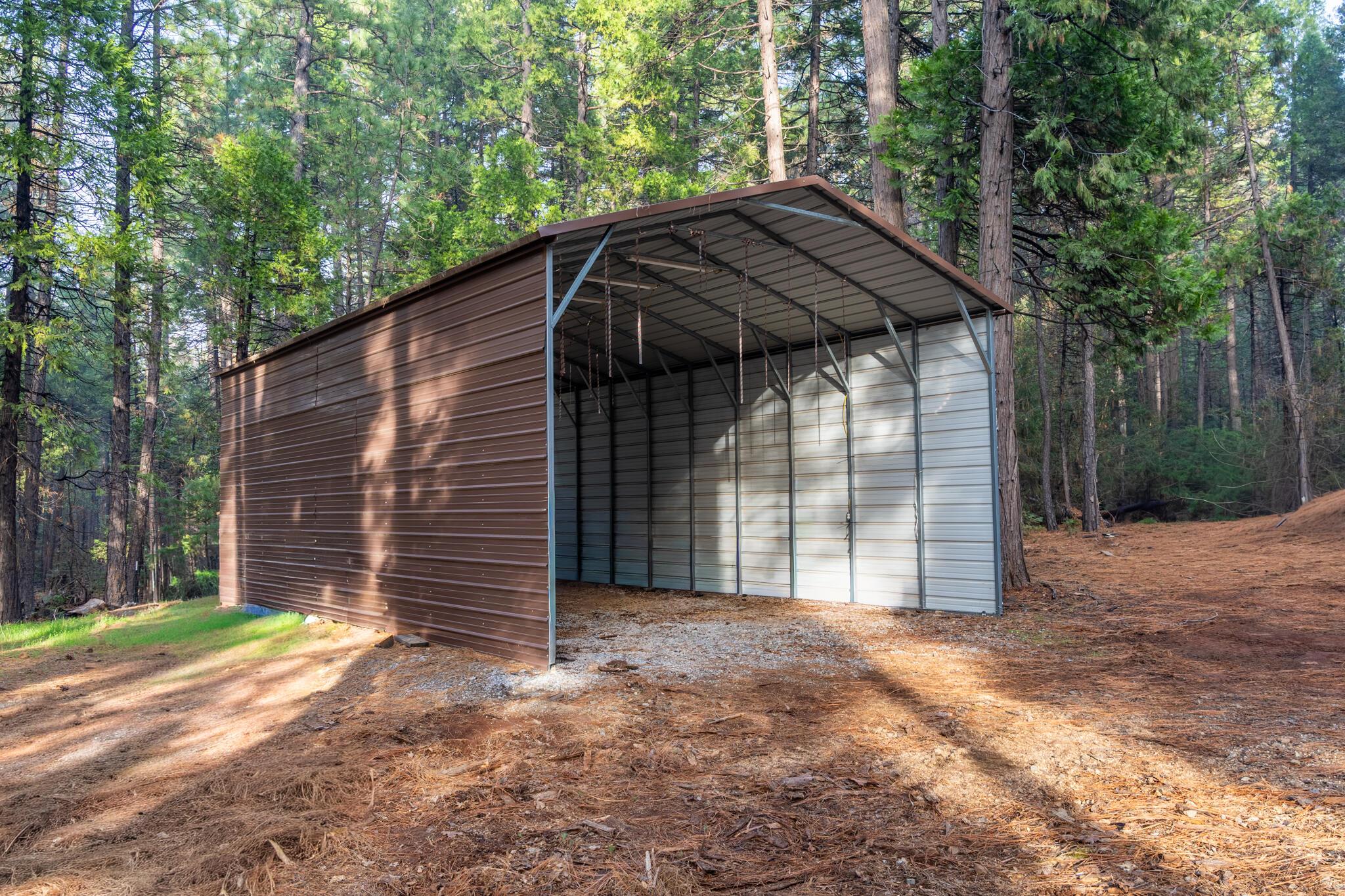 7795 Eastmoore Road Shingletown, CA 96088 - Photo 48 of 61 a backyard of a house with a small yard and large tree