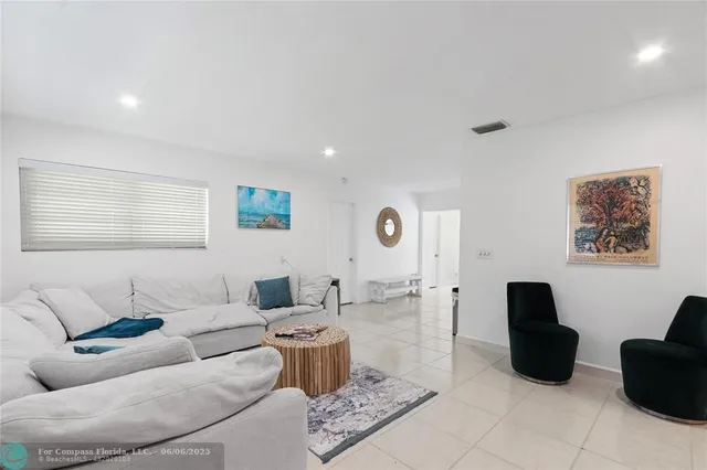 a large white kitchen with cabinets