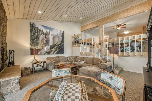 a living room with furniture and a chandelier