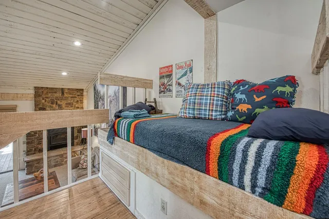 a bedroom with a bed and a view of kitchen