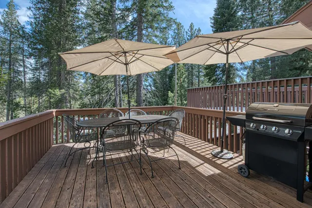a view of a deck with furniture and wooden deck