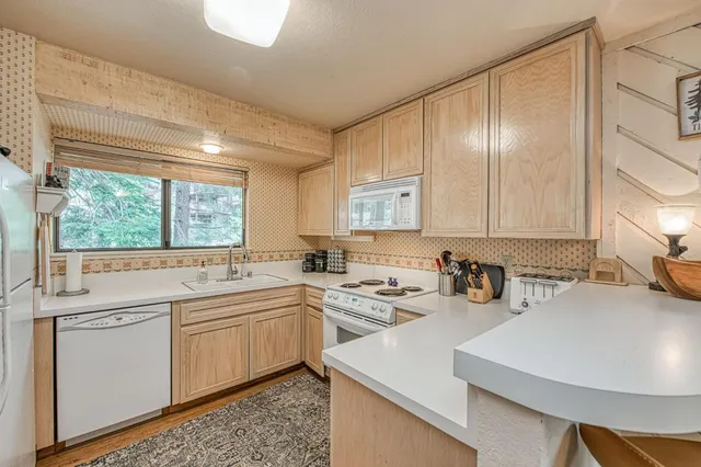 a kitchen with a sink a window and cabinets