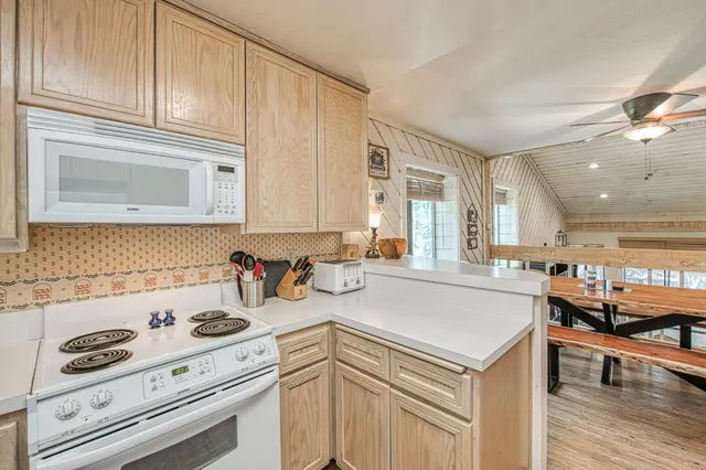 a kitchen with a sink a stove and cabinets
