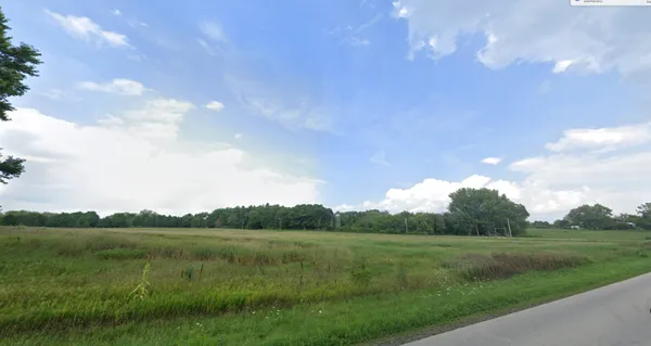a view of a lake and green valley