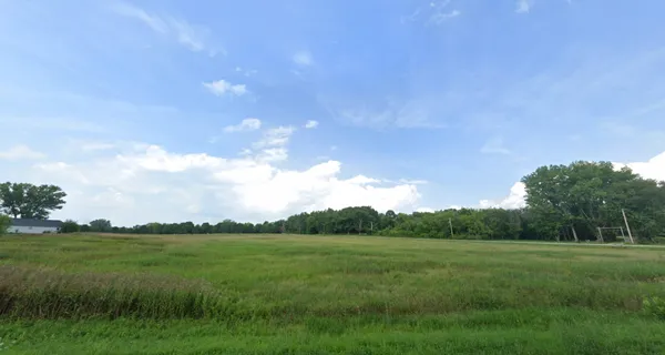 a view of a grassy field and mountains