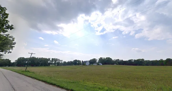 a view of grassy field with mountain