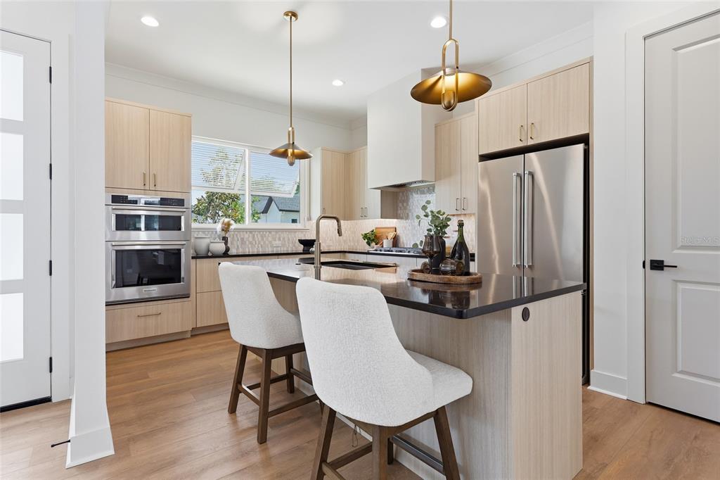 1063 Southwest 135th Way Newberry, FL 32669 - Photo 8 of 42 a kitchen with stainless steel appliances a dining table chairs and a refrigerator