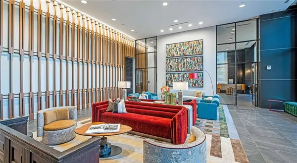 a living room with furniture and a book shelf