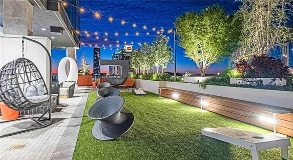 a swimming pool with outdoor seating and yard