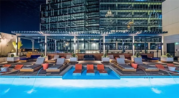 a room with lots of furniture and umbrella