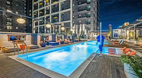 a view of a swimming pool with sitting area