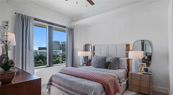 a bed room with a bed and a large window