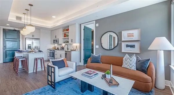 a living room with furniture and a wooden floor