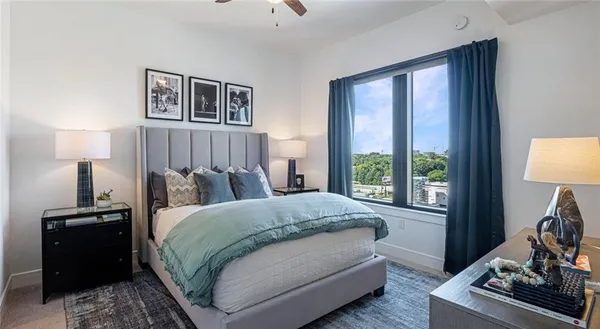 a bathroom with a granite countertop sink toilet a mirror and shower