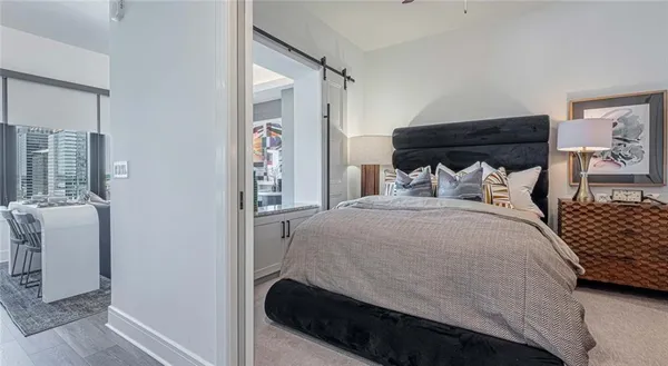 a bathroom with a granite countertop sink a toilet a mirror and shower