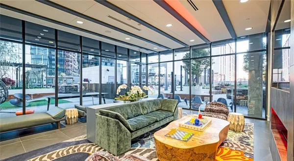 a living room with furniture and a floor to ceiling window