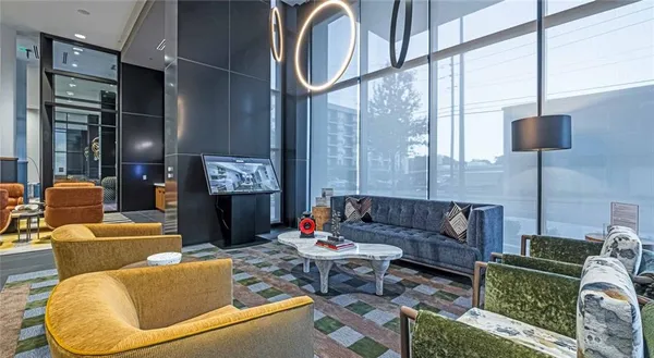 a living room with furniture a lamp and a large window