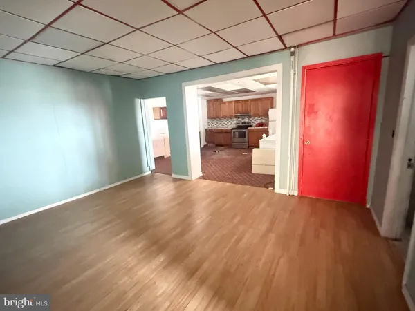 a view of a room with wooden floor