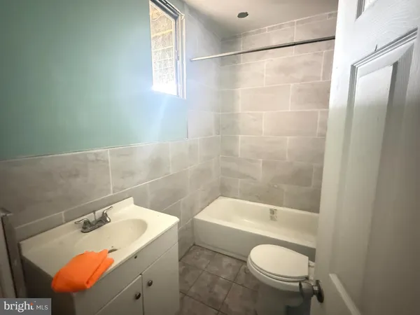 a bathroom with a sink mirror vanity and toilet