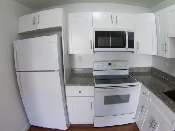 a kitchen with stainless steel appliances a stove a microwave and a refrigerator