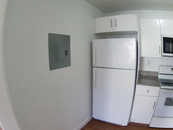 a utility room with wooden floor washer and dryer