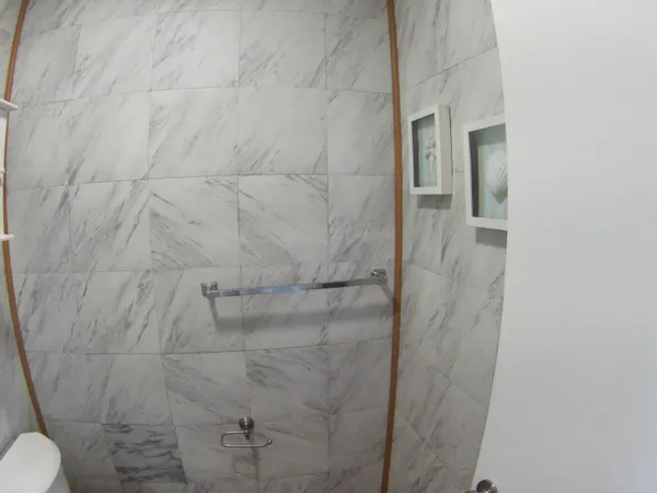 a bathroom with a toilet and a shower