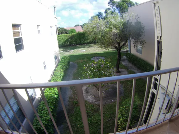 a view of balcony with yard
