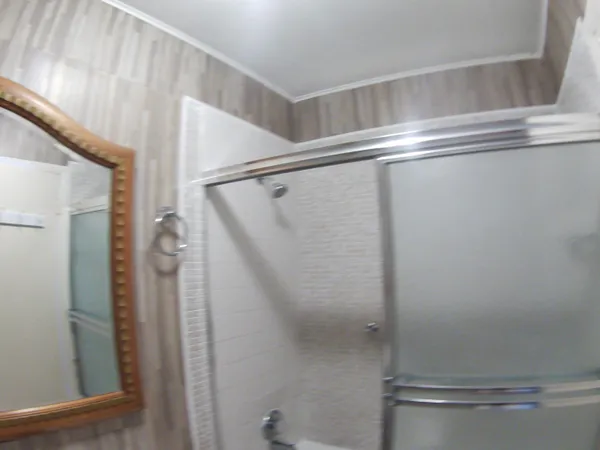 a bathroom with a glass shower door