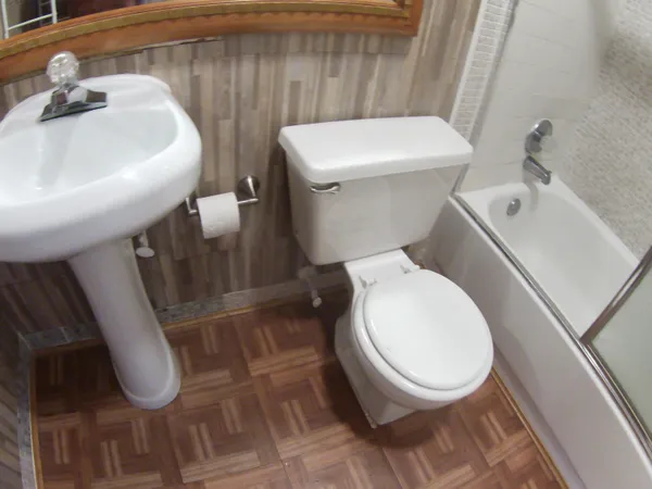 a white toilet sitting next to a white sink