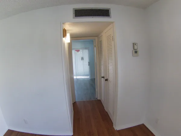 a view of a hallway with wooden floor