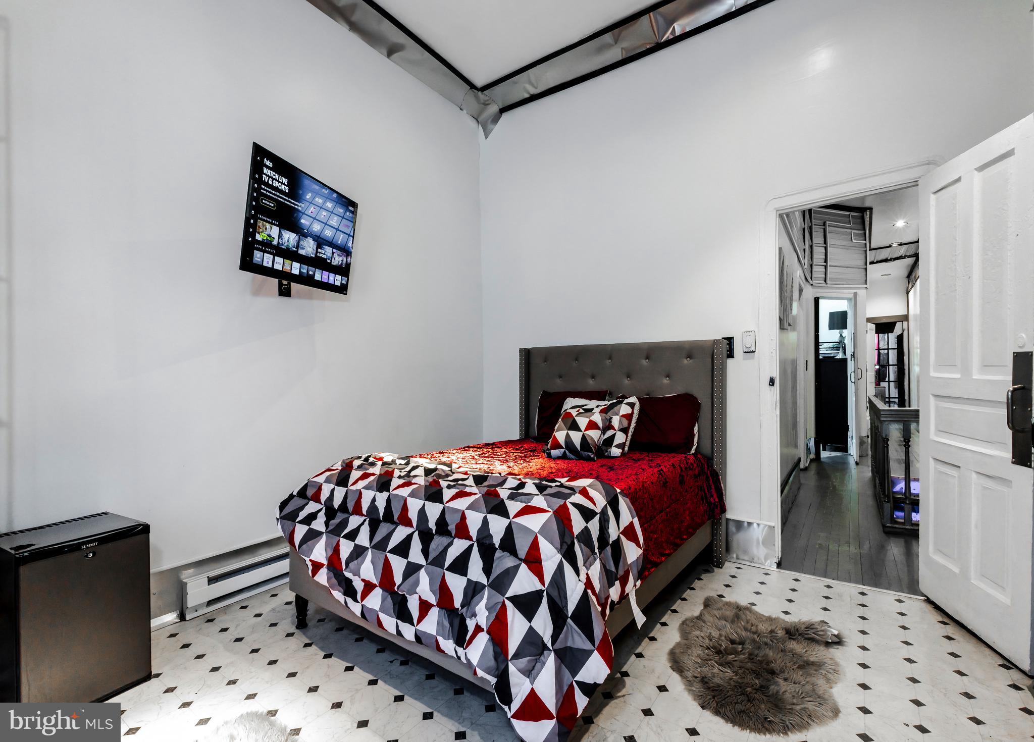 424 State Street Camden, NJ 08102 - Photo 22 of 36 a bedroom with a bed and a lamp on dresser