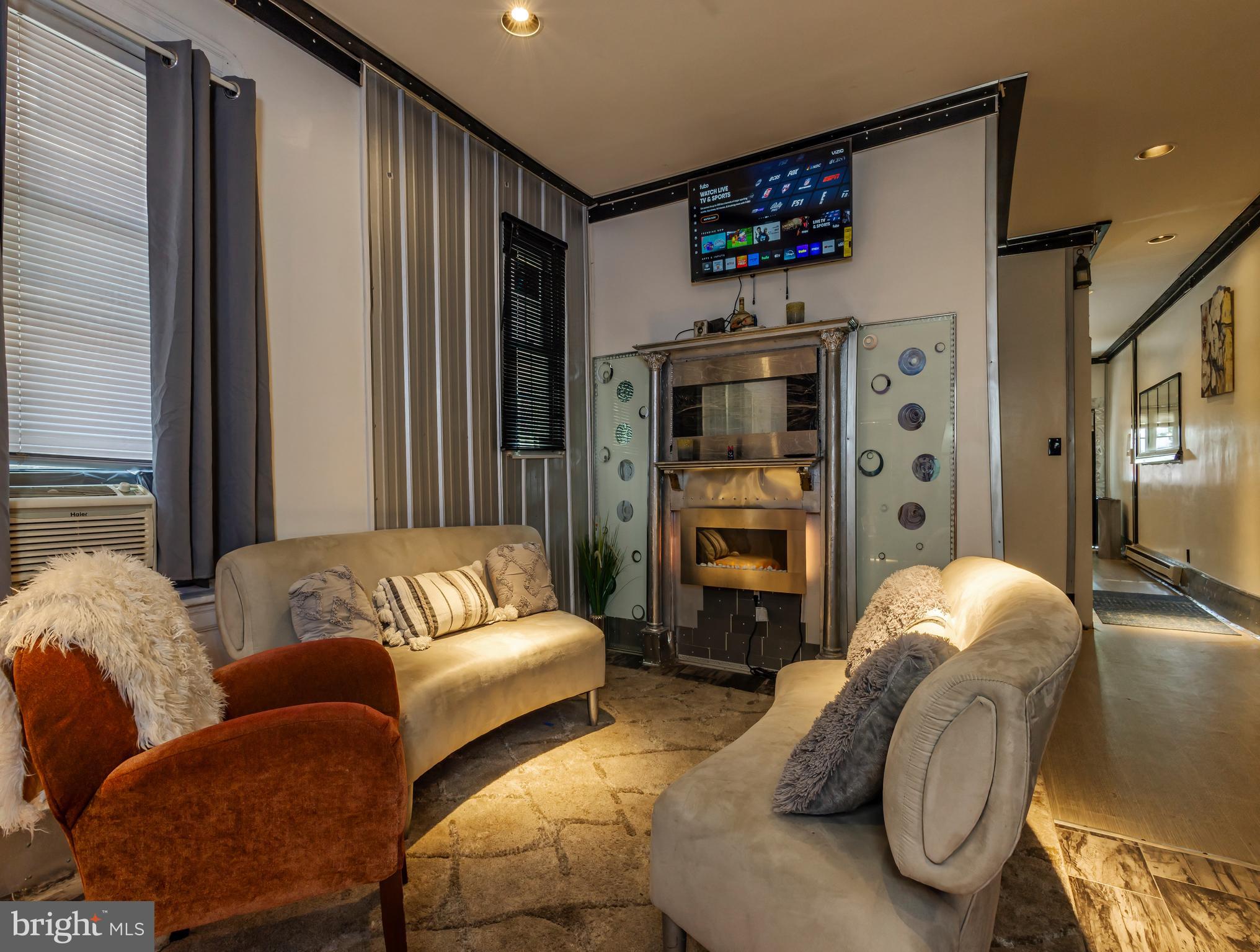 424 State Street Camden, NJ 08102 - Photo 7 of 36 a living room with furniture ceiling fan and a flat screen tv