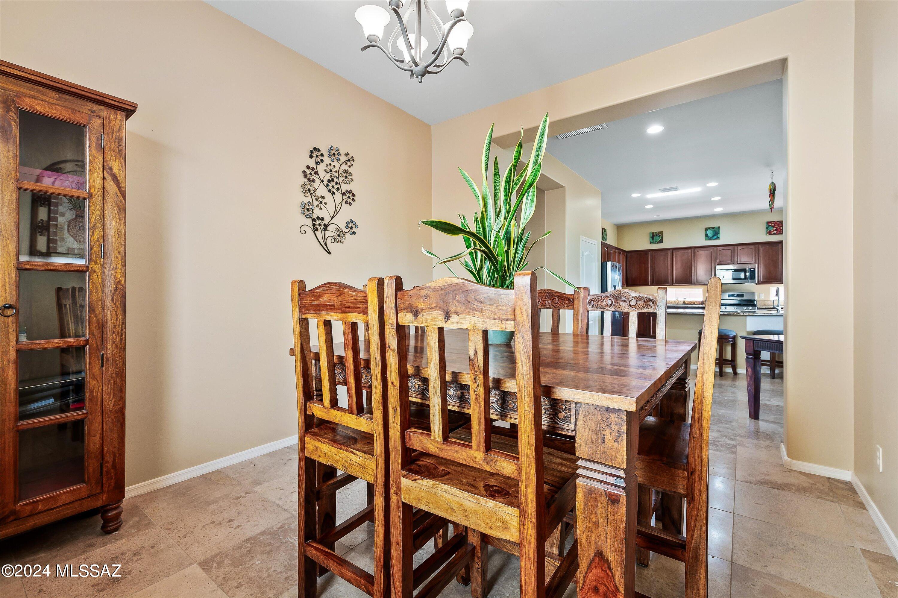 8579 North Shadow Wash Way Tucson, AZ 85743 - Photo 12 of 34 a view of a dining room with furniture and chandelier
