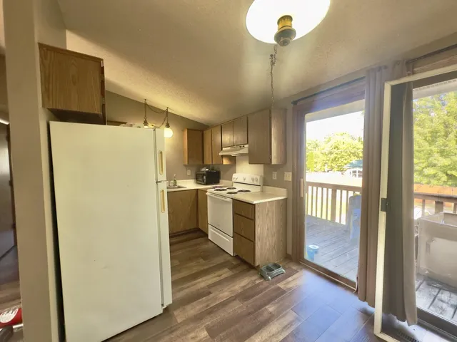 a kitchen with a refrigerator a sink and cabinets