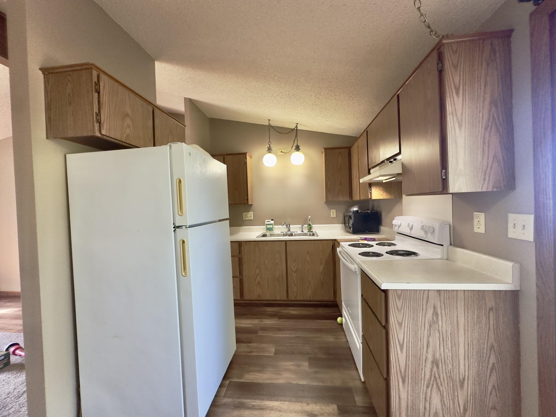 550 Hanabarger Street Lanark, IL 61046 - Photo 9 of 21 a kitchen with a refrigerator a stove top oven a sink and dishwasher