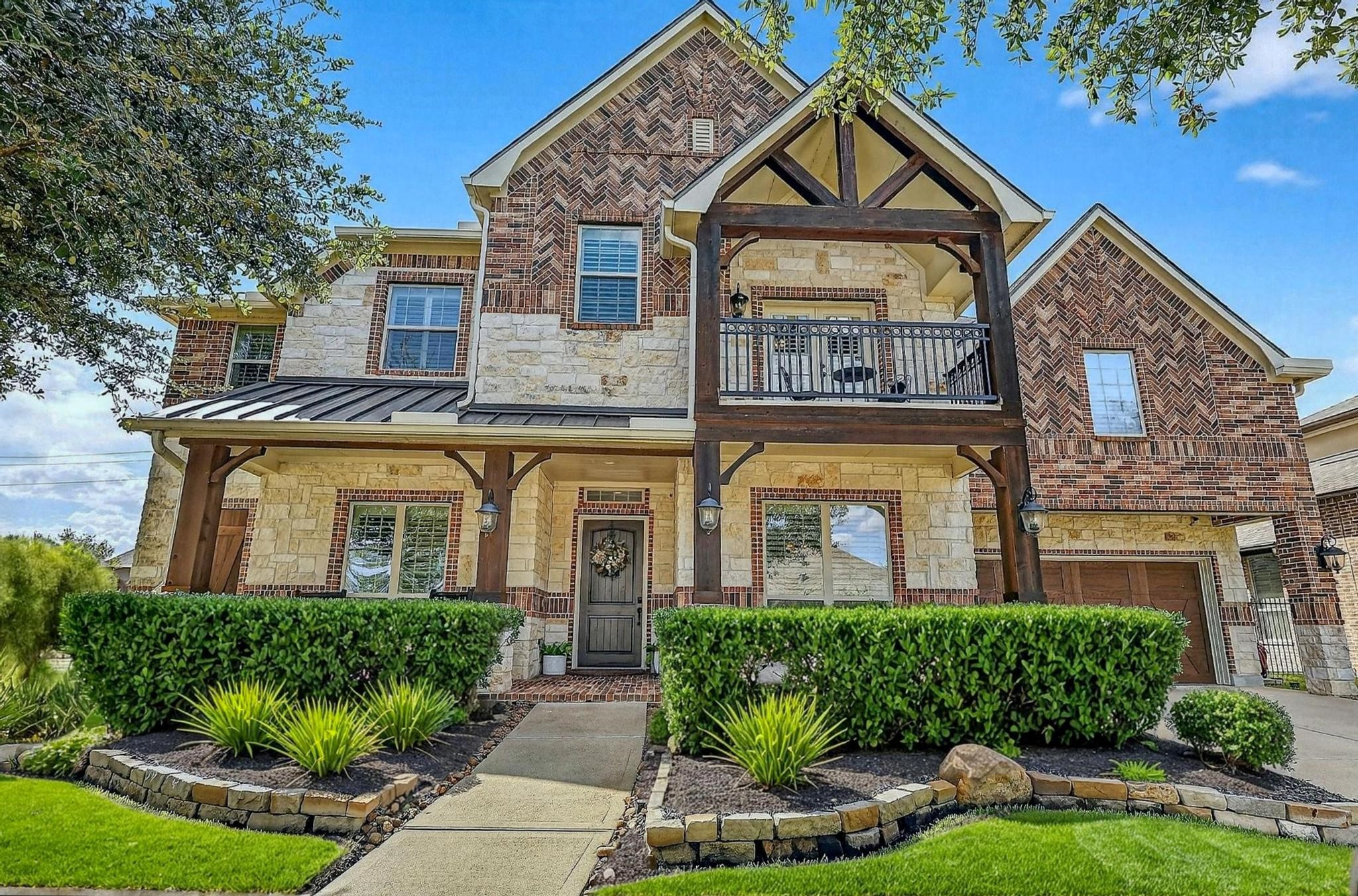 25803 Heritage Maple Drive Spring, TX 77389 - Photo 4 of 46 a front view of a house with a yard and potted plants