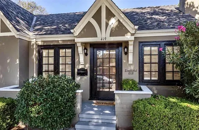 a front view of a house with a yard garage and outdoor seating