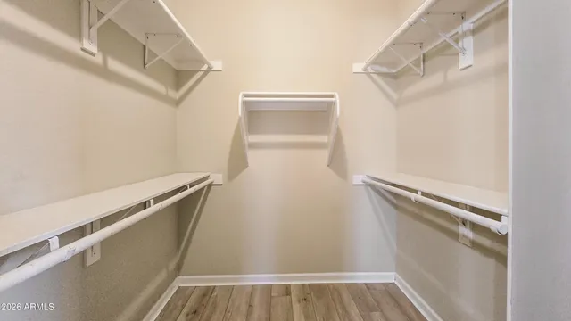 a bathroom with a granite countertop toilet a sink and a mirror