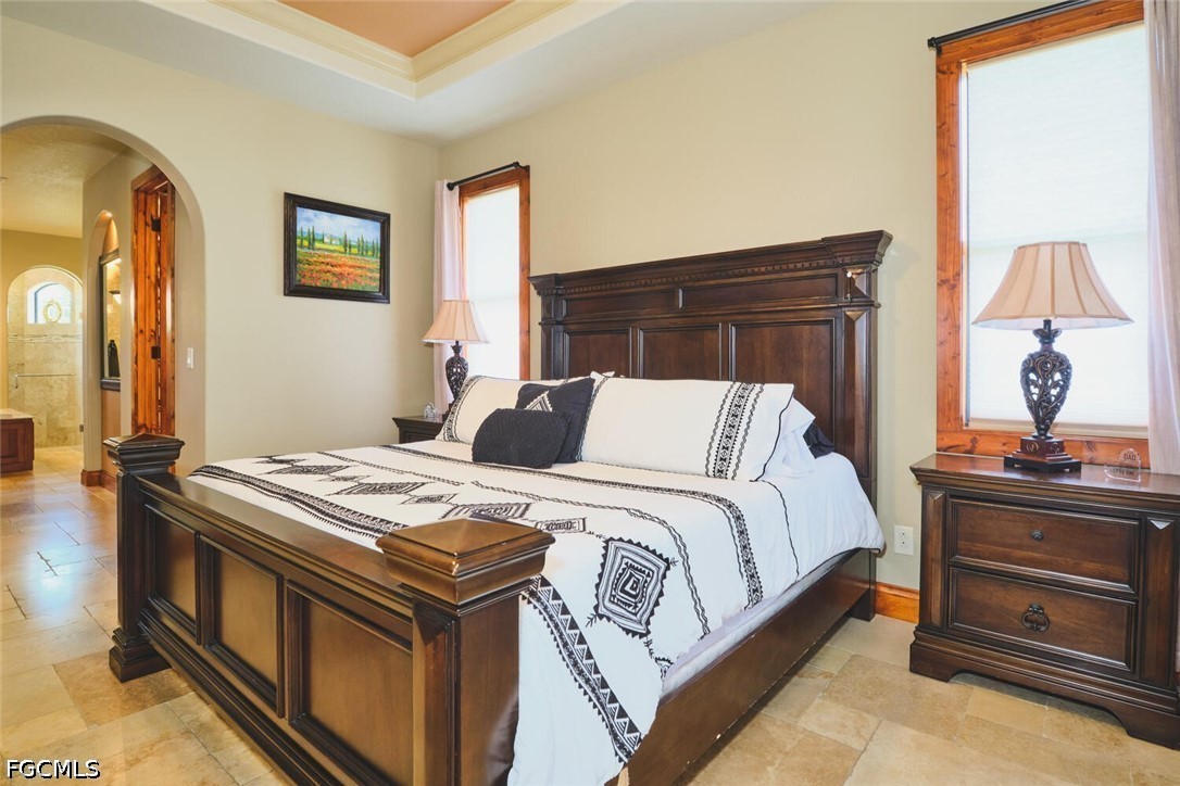 5306 Southwest 27th Place Cape Coral, FL 33914 - Photo 17 of 50 a bed sitting in a bedroom next to a window and dresser