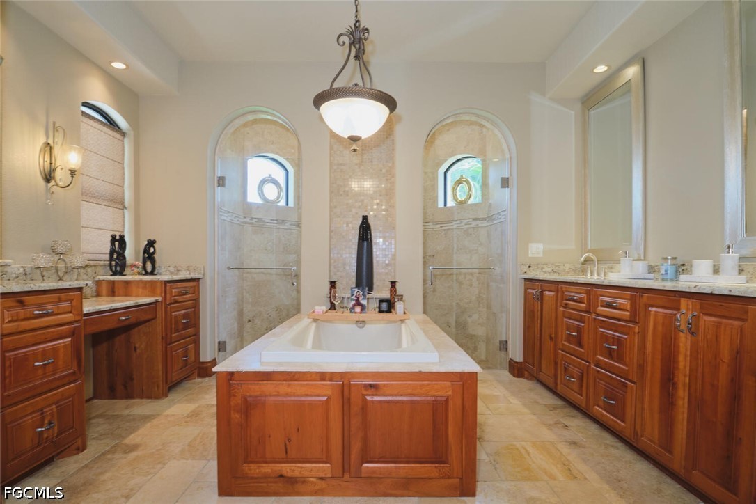 5306 Southwest 27th Place Cape Coral, FL 33914 - Photo 18 of 50 a bathroom with a granite countertop sink a large mirror and a vanity