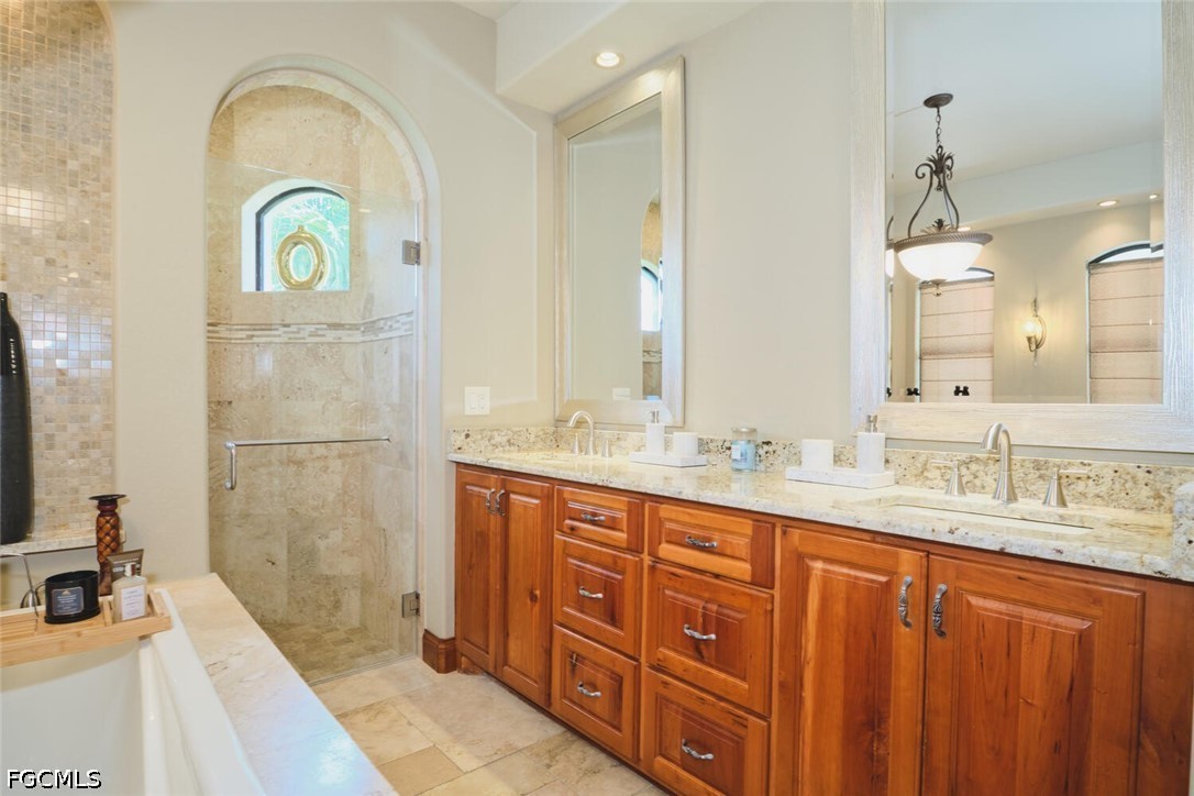 5306 Southwest 27th Place Cape Coral, FL 33914 - Photo 19 of 50 a bathroom with a granite countertop sink a mirror and shower