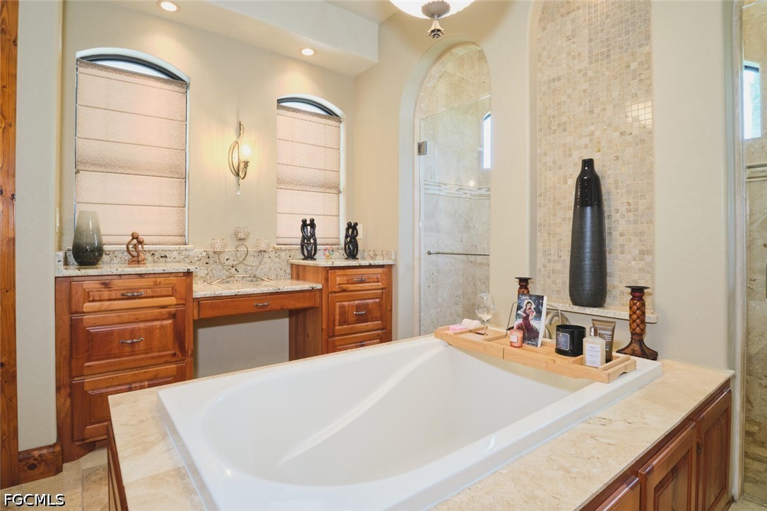 5306 Southwest 27th Place Cape Coral, FL 33914 - Photo 20 of 50 a bathroom with a tub sink and mirror