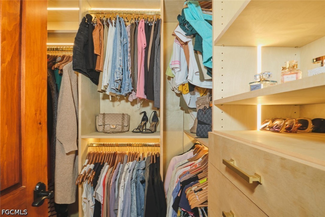 5306 Southwest 27th Place Cape Coral, FL 33914 - Photo 22 of 50 a view of walk in closet with clothes and shoes