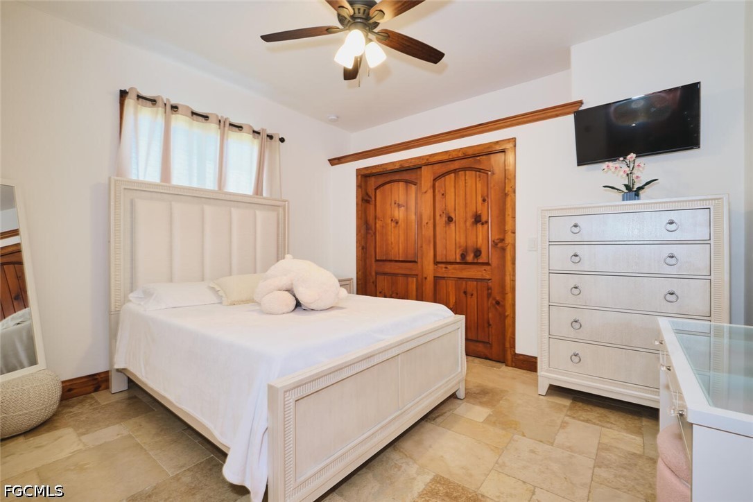 5306 Southwest 27th Place Cape Coral, FL 33914 - Photo 23 of 50 a bedroom with a bed and a flat screen tv