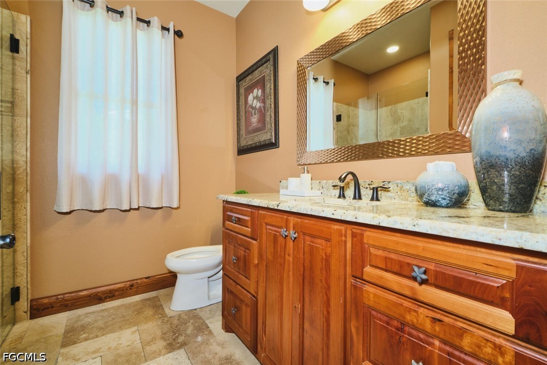 5306 Southwest 27th Place Cape Coral, FL 33914 - Photo 24 of 50 a bathroom with a granite countertop sink and a mirror