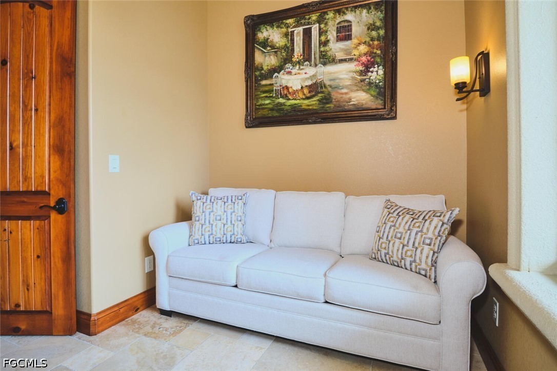 5306 Southwest 27th Place Cape Coral, FL 33914 - Photo 28 of 50 a living room with furniture and a painting on the wall